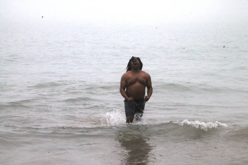 One of the last people into the water took a moment to celebrate the accomplishment. 