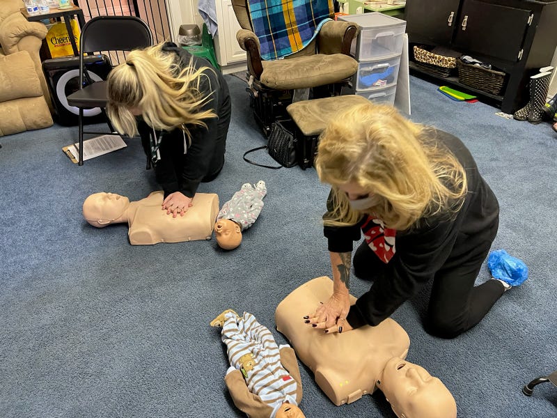 K-Frog's Pepper and Heather practice CPR on dummies at Life First Training Center