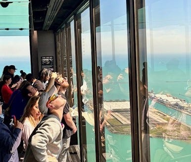 Crowds of people crane their necks to get a better look at the eclipse from 875 N. Michigan Ave., formerly known as the John Hancock Building.