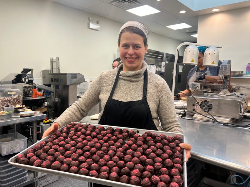 Katherine Duncan, owner of Katherine Anne Confections, holds up a tray of truffles at the production kitchen at the Iriving Park location. The cafe features a full service espresso bar, along with several sweet treats, including truffles, caramels and marshmallows. 