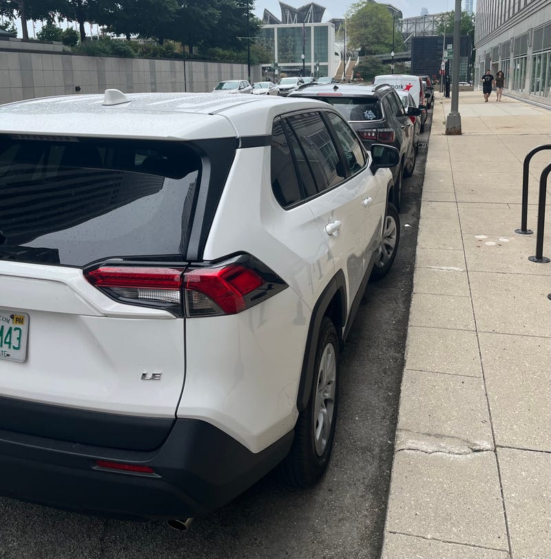 Cars parked near the AON Building and Millennium Park.