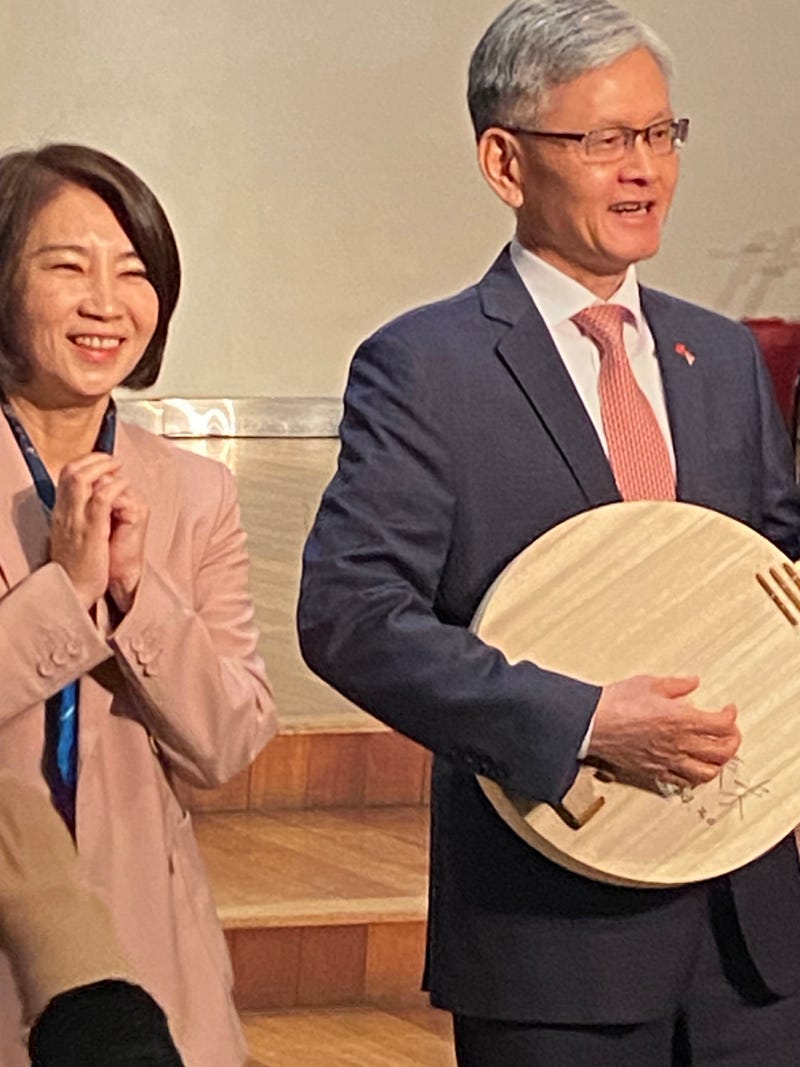 Ambassador James K.J. Lee of the Taipei Economic and Cultural Office in New York tries out the moon guitar, next to the magistrate of Pingtung County, Chou Chun-mir at the "Tunes from the Islands: An AAPI Celebration Event," on April 30, 2024.