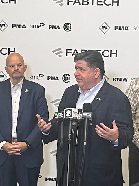 Illinois Governor J.B. Pritzker answers questions after a tour of the FABTECH trade show at McCormick Place.