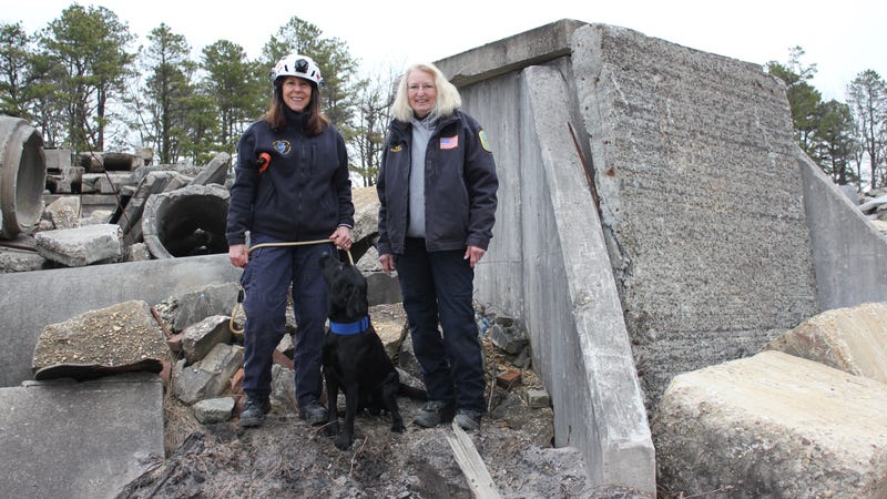 Cassey with his handler, Lori Stevens (left), and K-9 Coordinator Alice Holmes (right).