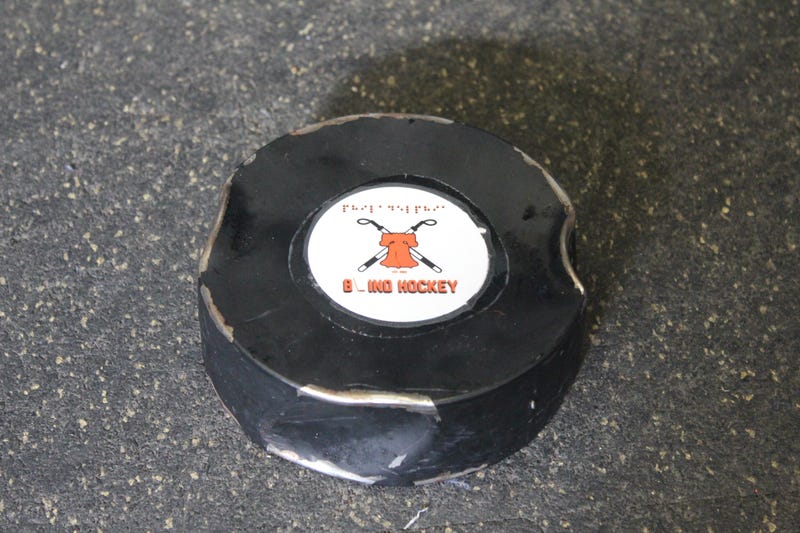 A dented blind hockey puck