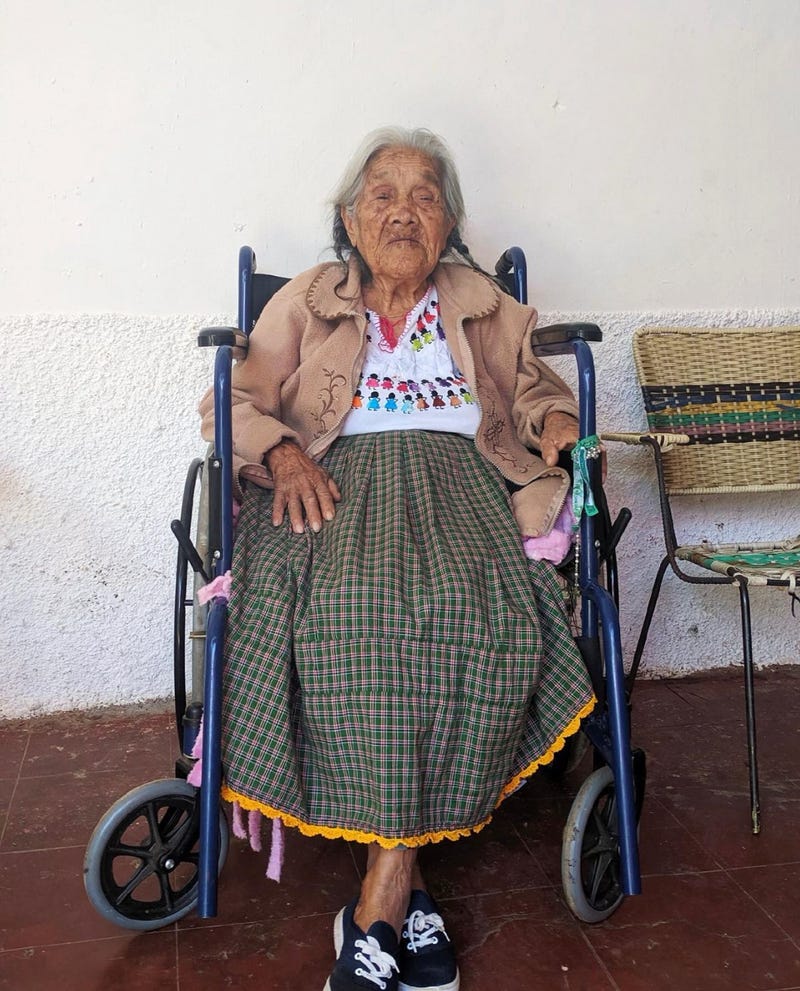 Mama Coco sitting on a wheels chair