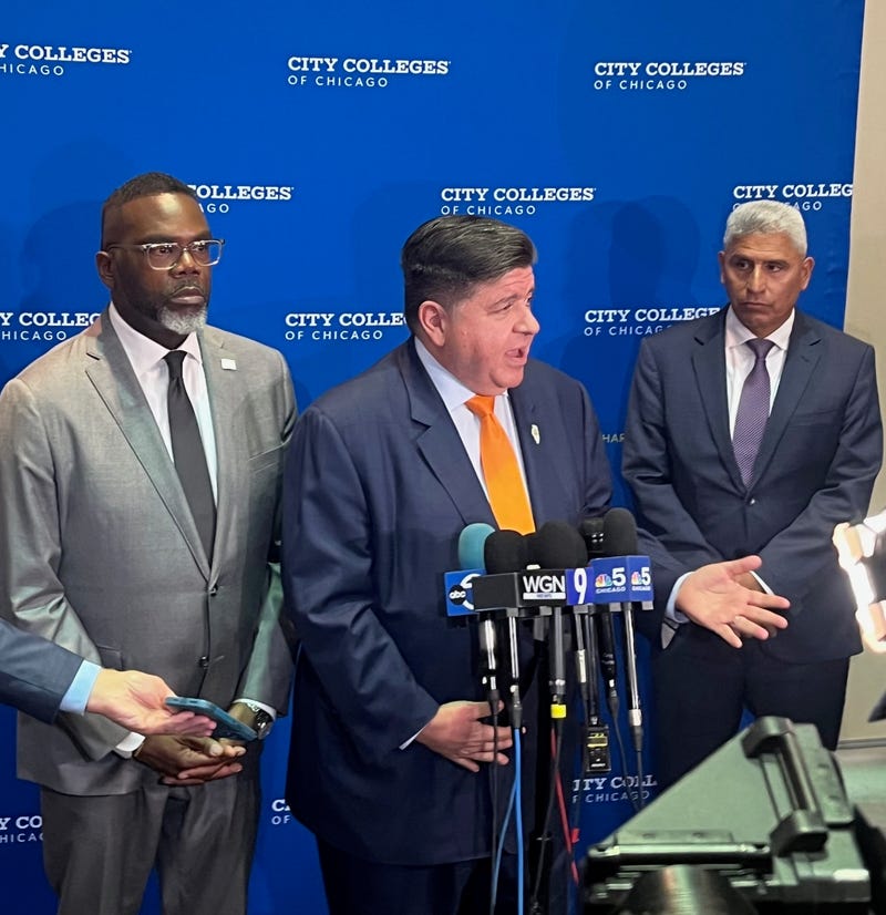 Illinois Governor J.B. Pritzker talks to reporters at Kennedy-King College in Chicago's Englewood neighborhood, flanked by Chicago mayor Brandon Johnson (left) and City Colleges chancellor Juan Salgado.