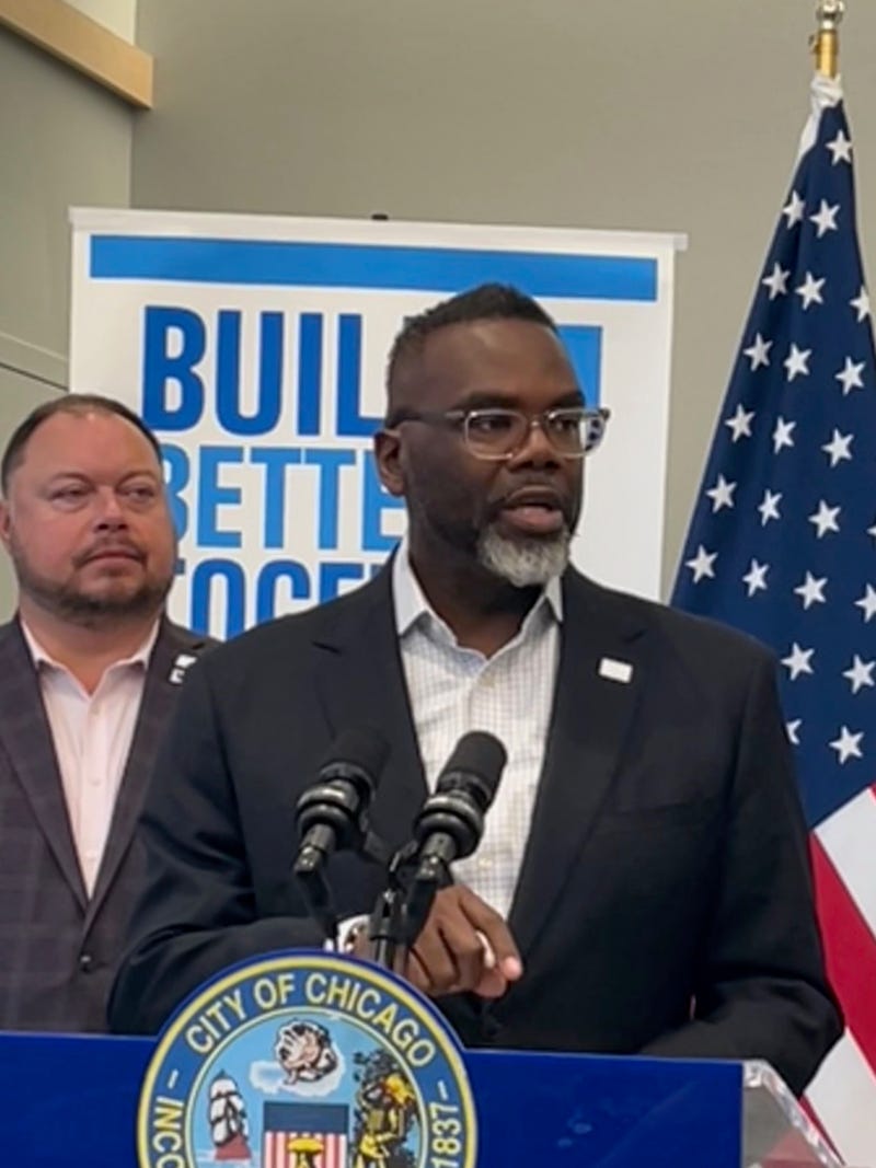 Chicago mayor Brandon Johnson answers questions from reporters during an event in the city's Lakeview neighborhood. Alderman Bennett Lawson (44th Ward) is behind the mayor.