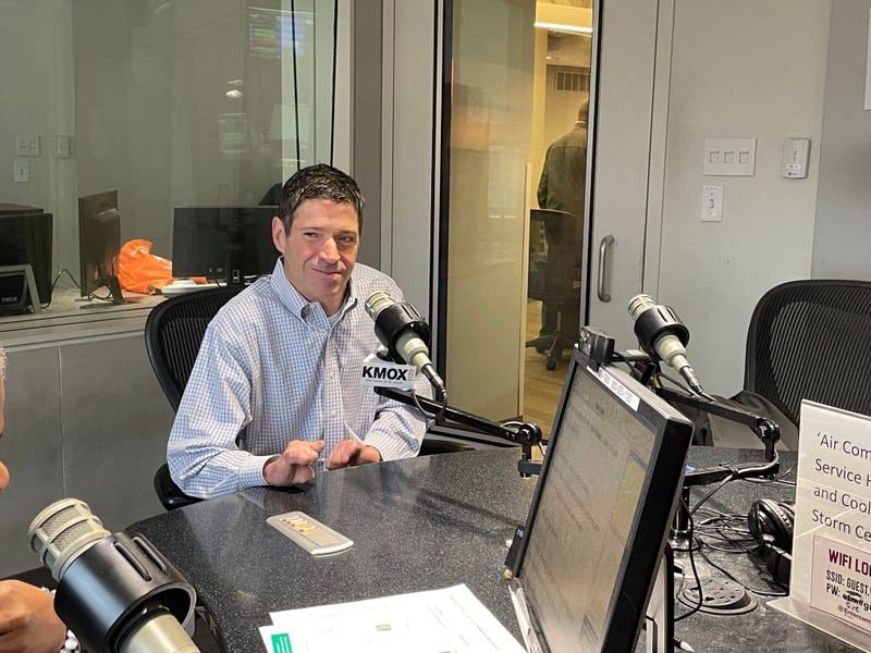 john o'leary at kmox microphone. he is a white man with a blue button down on