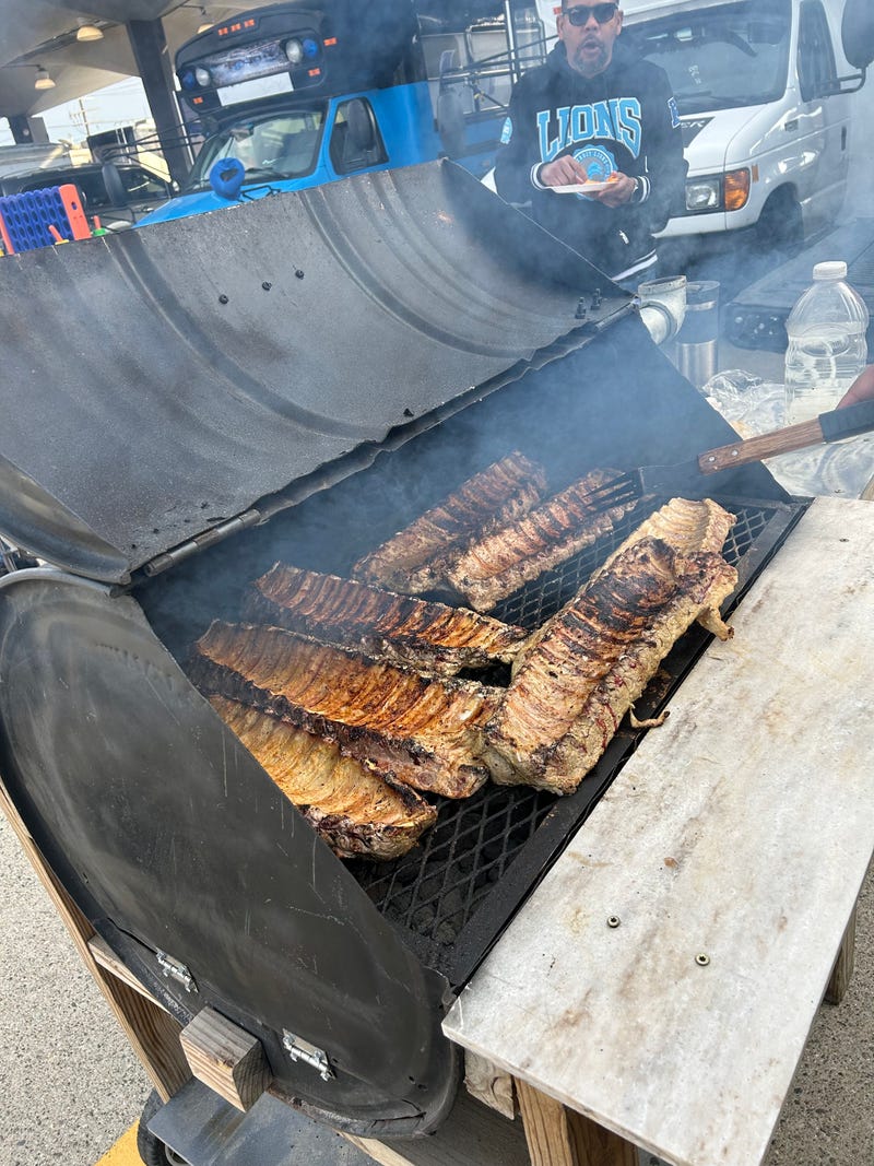 Jamon Hamilton prepares ribs at Eastern Market tailgate ahead of Lions' home opener.
