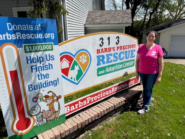 Barb Weber poses for a photo outside of Barb's Precious Rescue, a 7,500-square-foot space dedicated to rescue cats and kittens.