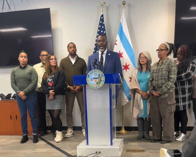 Chicago mayor Brandon Johnson (center) talks to reporters at City Hall, joined by members of the City Council's Progressive Caucus.