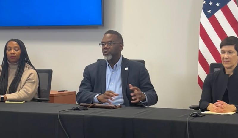 Chicago mayor Brandon Johnson talks to reporters at City Hall, flanked by Budget Director Annette Guzman (left) and city Chief Financial Officer Jill Jaworski.