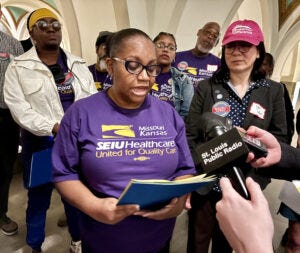 Katherine Stewart, who works at Highland Rehabilitation and Health Care and is a union steward, speaks to reporters Wednesday.