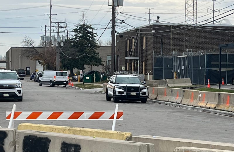 Police vehicles surround the ICE processing facility in Broadview. Concrete barriers on Beach Street block traffic.