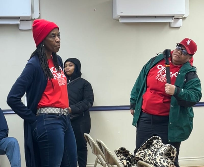 A member of the "Chicago Flips Red" group voices criticism of rising property taxes in the city during a union event featuring Mayor Brandon Johnson.