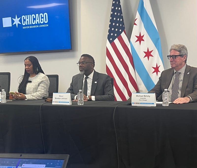 Chicago budget director Annette Guzman (left), Mayor Brandon Johnson, and comptroller Michael Belsky speak to reporters at City Hall.