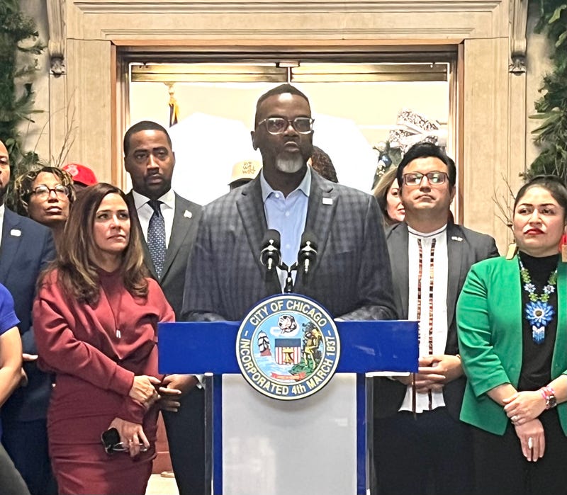 Chicago mayor Brandon Johnson is joined by supporters as he addresses reporters outside his office on the fifth floor of Chicago City Hall. 