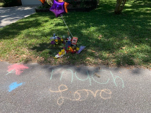 A message of love is written in chalk on the road where Ahmaud Arbery died