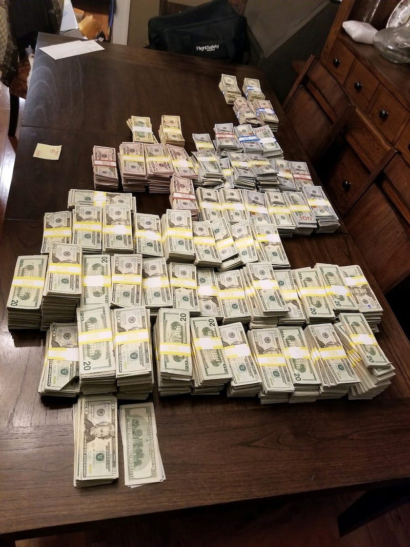 Police allegedly found almost $900,000 and ledgers detailing an illegal operation selling fake COVID vaccination cards when they searched Julie DeVuono's home.
