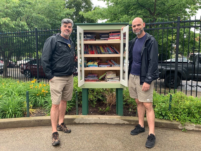 Spring Garden Civic Association President Patrick Boyle (left) and board member Brad Jamula show the new Little Free Library box, which Jamula built, in Clemente Playground.