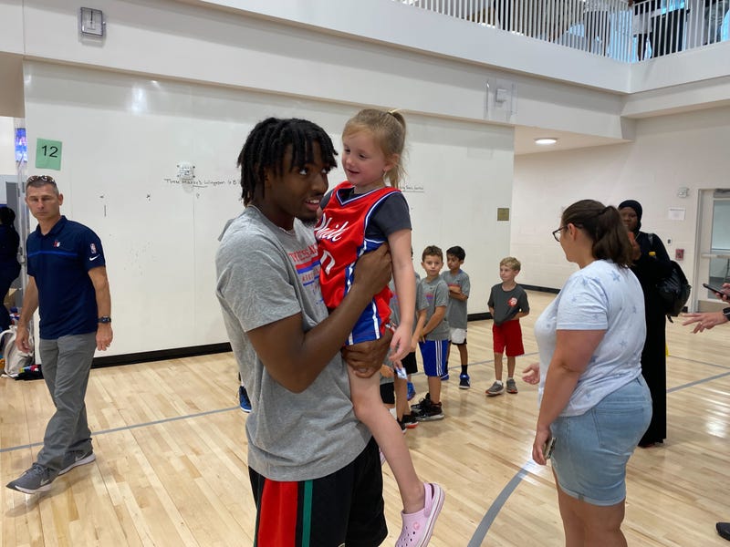 76ers star Tyrese Maxey picks up Alex Evans' daughter Thelma at his free basketball camp Saturday at William Penn Charter School.