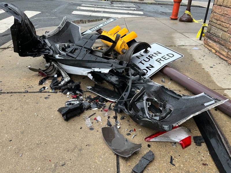 Pieces of a car and a downed spotlight are left at 15th and South streets, where an alleged road rage shooter hit three cars and fled after shooting a 17-year-old driver.