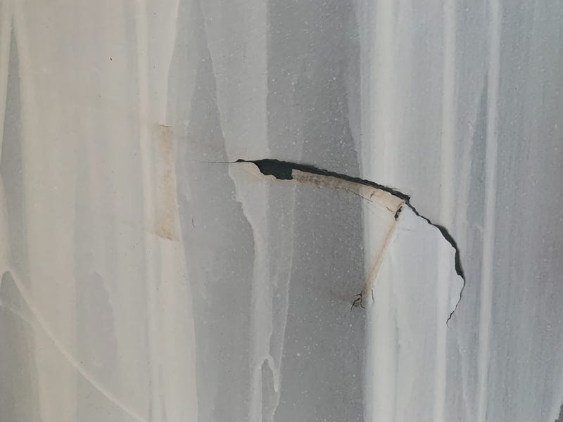 Up close, scratches and tears can be seen in the murals.