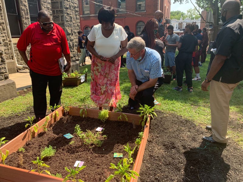 Pennsylvania Agriculture Secretary Russell Reading (kneeling) in an Urban Ag Week event at Boys Latin Charter Middle School.