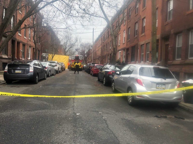 A yellow tarp placed outside the location of a fire that killed 13 people in Philadelphia's Fairmount neighborhood. The tarp was used to block the view as victims were being taken out of the duplex where it happened.