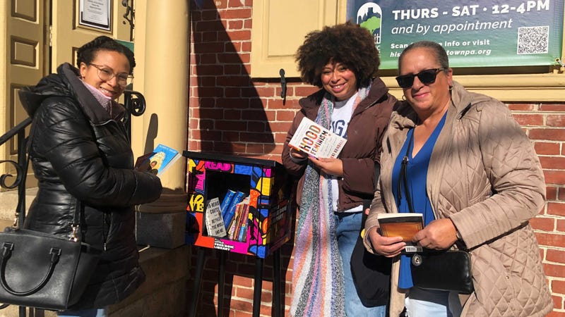 Loraine Carter and her two daughters Jaquianna and Tianna Carter visit one of the Little Free(dom) Library boxes.