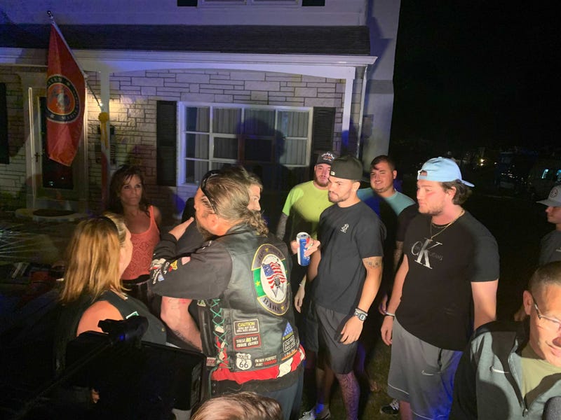 Lance Corporal Thomas Plotts embracing loved ones after returning from Afghanistan.