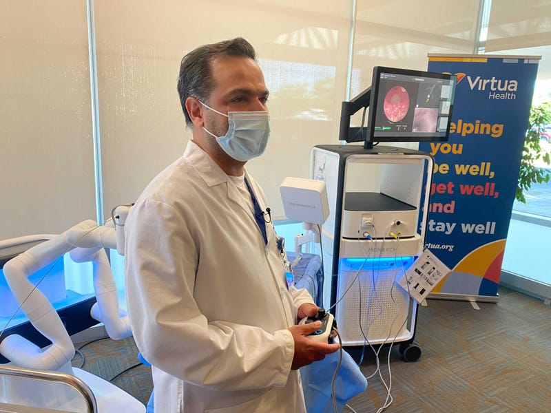 Dr. Syed Riaz, interventional pulmonologist at Virtua Health in Marlton, New Jersey, operates a robot that can navigate the lungs, using an Xbox-style controller.