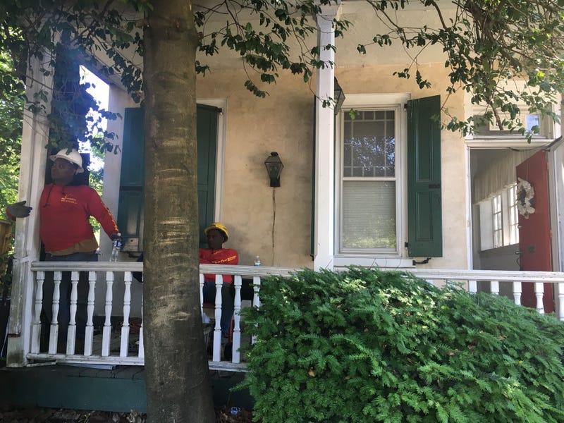 Workers on the porch of the historic Pearson House.