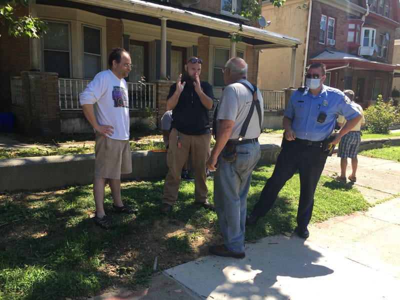 Aaron Wunsch, a nearby neighbor, talking with an L&I staff member about saving the historic Pearson house from demolition.
