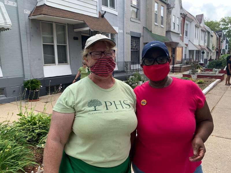 Sally McCabe with the Pennsylvania Horticultural Society (left) and Patricia Jamison, Rowan Walkway block captain, teamed up for a neighborhood cleanup day in the Nicetown-Tioga section.