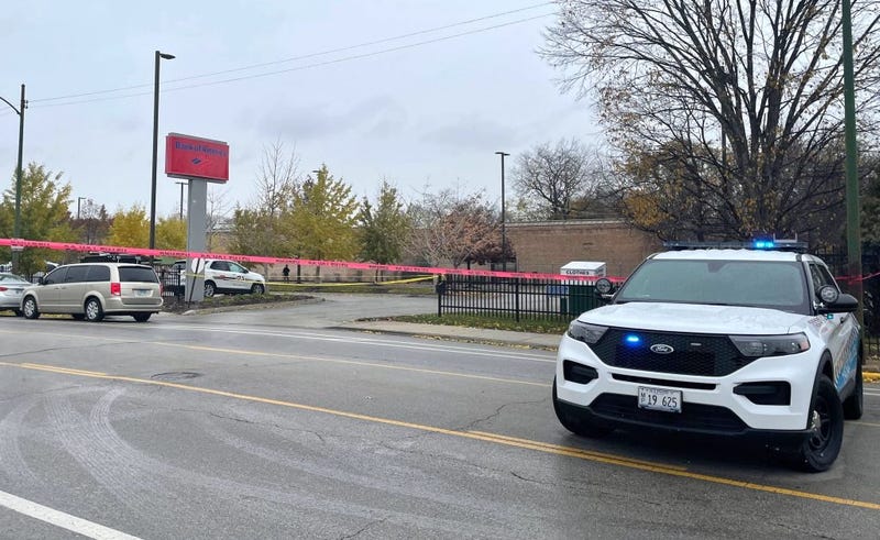 Police investigate Monday where two armored truck guards were shot at a BMO Harris Bank branch in Chatham.