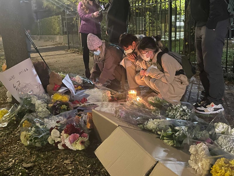 U. of C. staff members, students and friends of Zheng — many of them holding bouquets of flowers — stopped by a memorial in the 1000 block of East 54th street Wednesday evening.