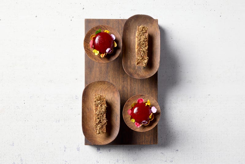 The pani puri (top left and bottom right) and the galouti (top right and bottom left) at Indienne. Although the two dishes change slightly with each new menu, the latest version of the pani puri features blackberry and tamarind in a buckwheat tart, while the galouti is an eclair with mushroom, goat cheese, and truffle