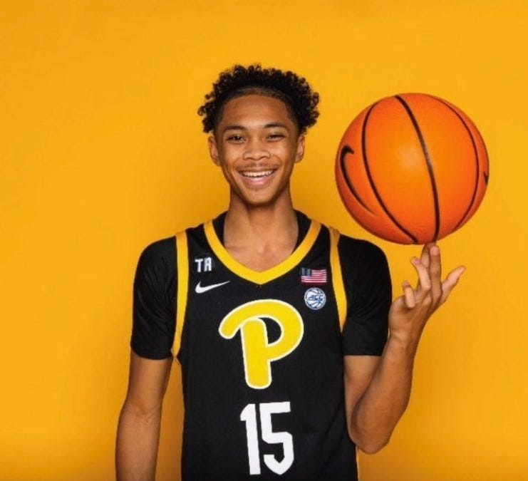Jaland Lowe spinning a ball with a Pitt uniform