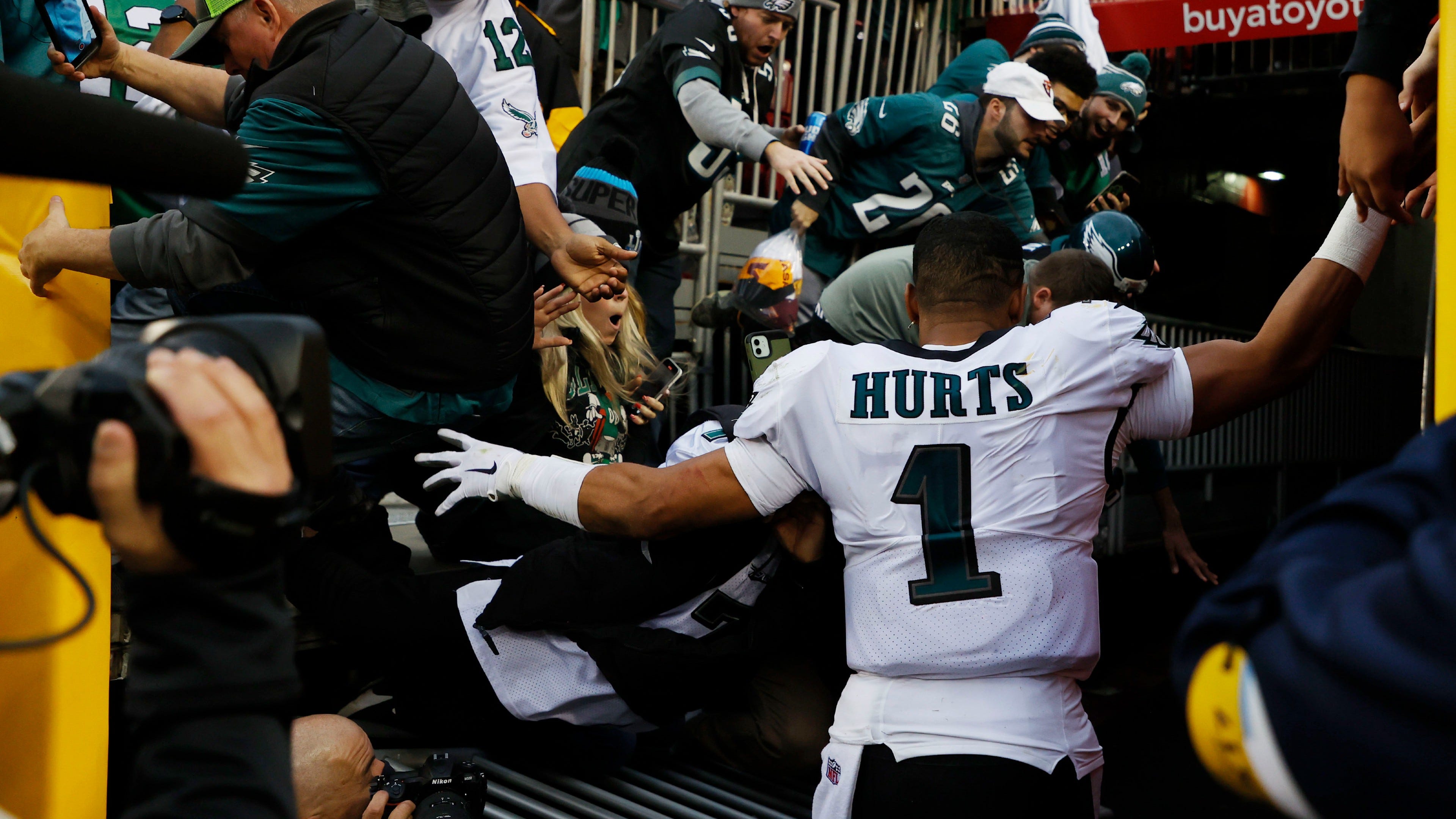 Fans nearly fall on Jalen Hurts as he exits FedExField