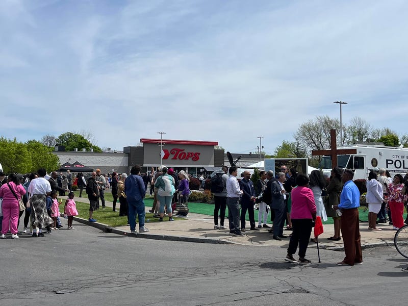 A community comes together at a site near the Tops shooting