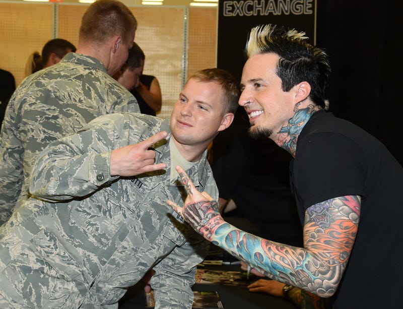 Staff Sgt. Michael Gigliotti poses for a photo with drummer Jeremy Spencer of Five Finger Death Punch at Nellis Air Force Base