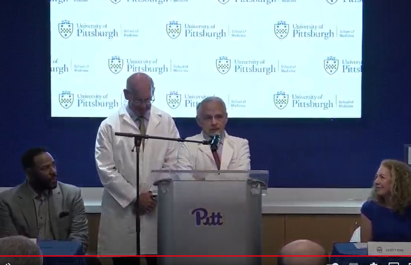 Dr. Joseph Maroon speaks while Jerome Bettis watches on
