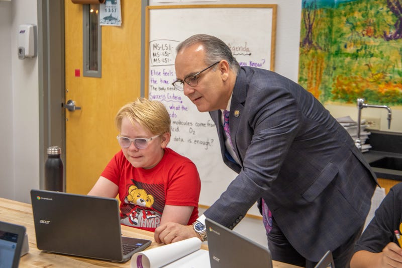 Clark County School District Superintendent Dr. Jesus Jara assists a student