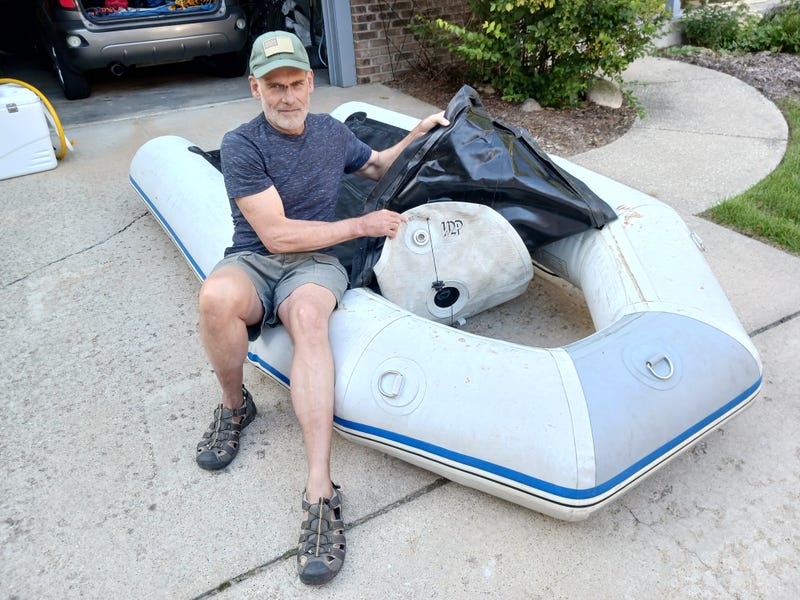 Dreyer showing damage done to his dinghy from the pounding waves on Lake Michigan