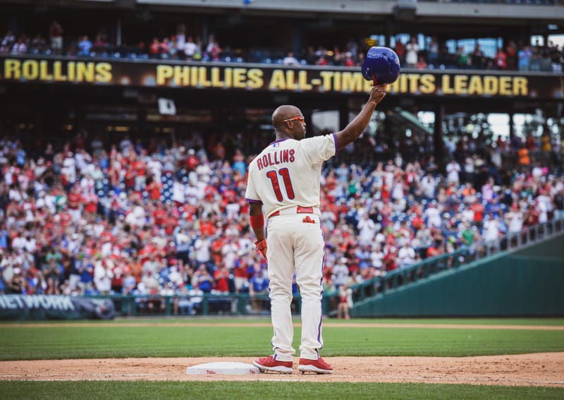 Rollins tips his helmet to fans during his final Phillies season in 2014 after becoming the team's all-time hit leader.