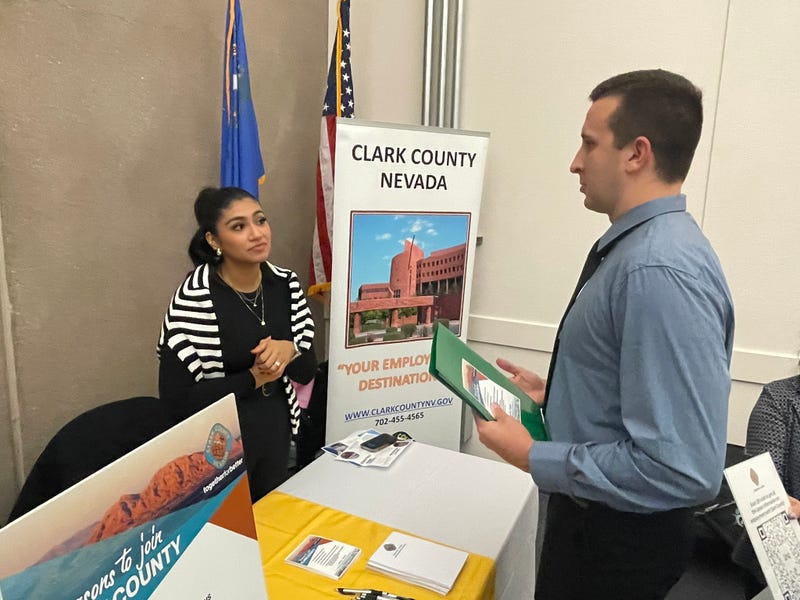 An employer chats with an applicant during a job fair.