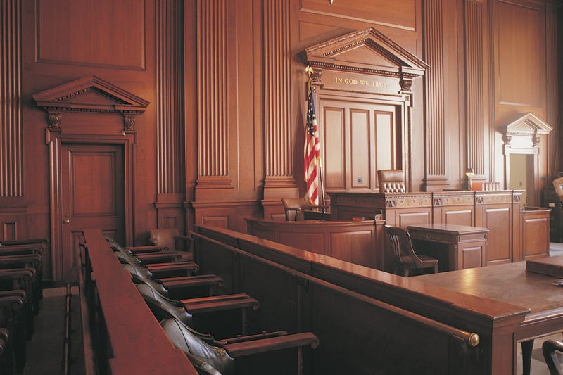 An empty courtroom, with a view from the juror's box