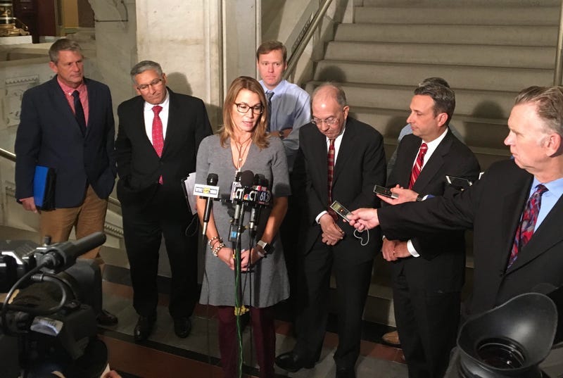 Former Connecticut House Minority leader Themis Klarides (at center left, behinds microphones)